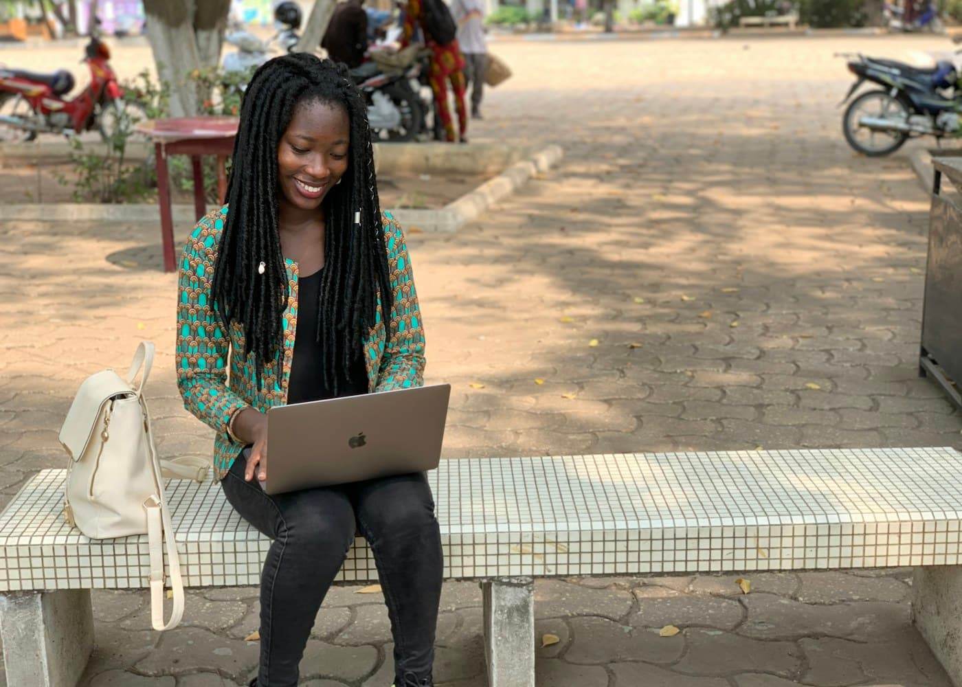 A learner working through a lesson on a laptop away from home